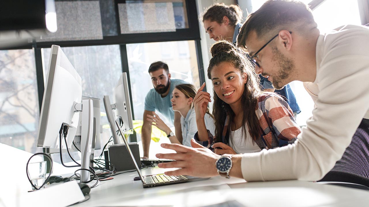 Image of software developers practicing the scrum values leveraging agile to improve their processes.